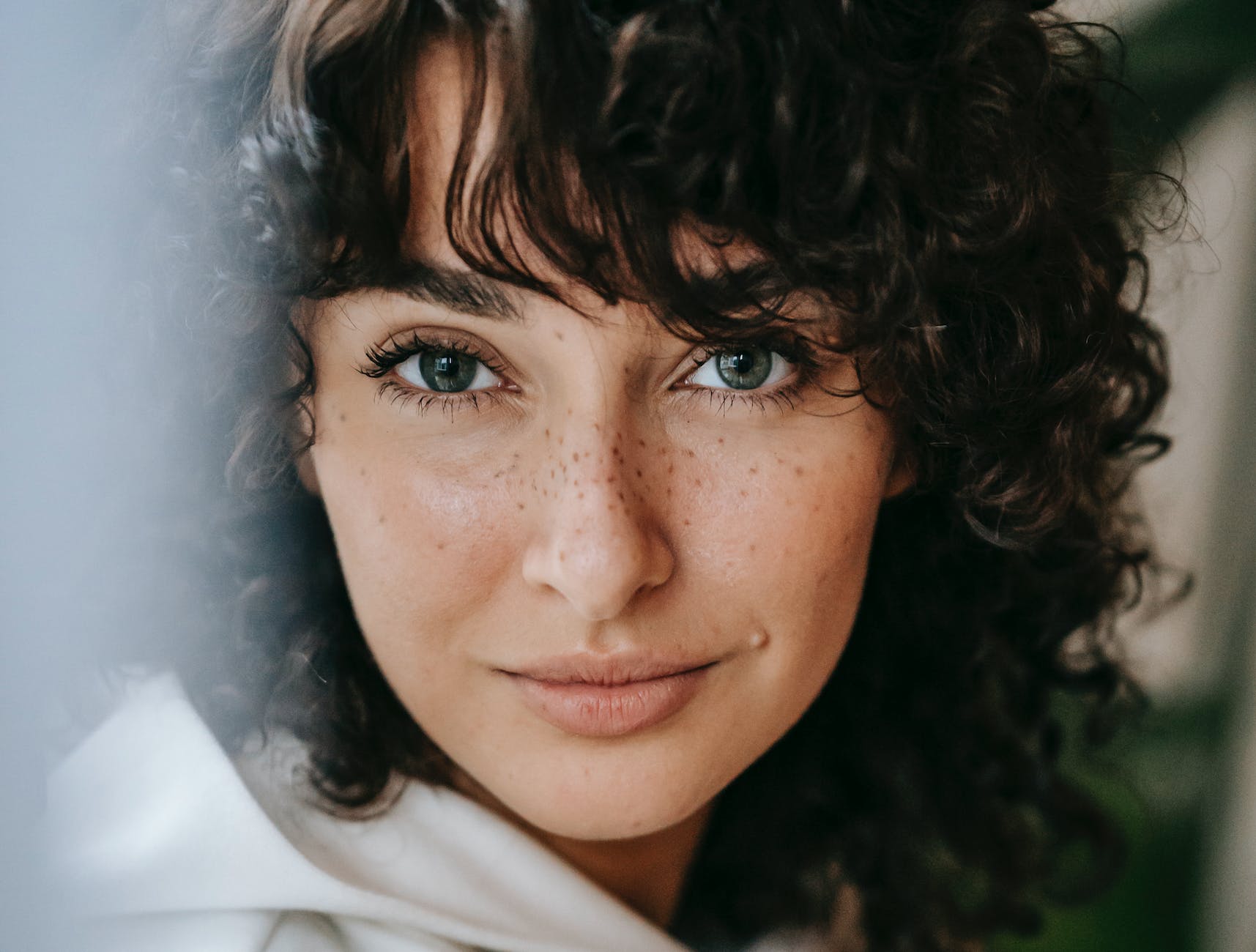charming woman with freckles in room
