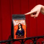 a person pointing to a pack of coffee