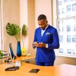 man standing while using phone