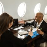 business partners having a discussion on a private jet