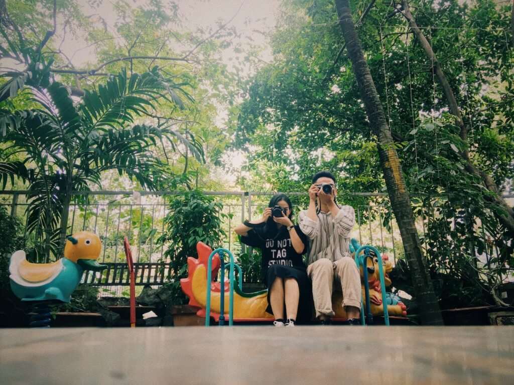 man and woman holding cameras