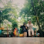 man and woman holding cameras